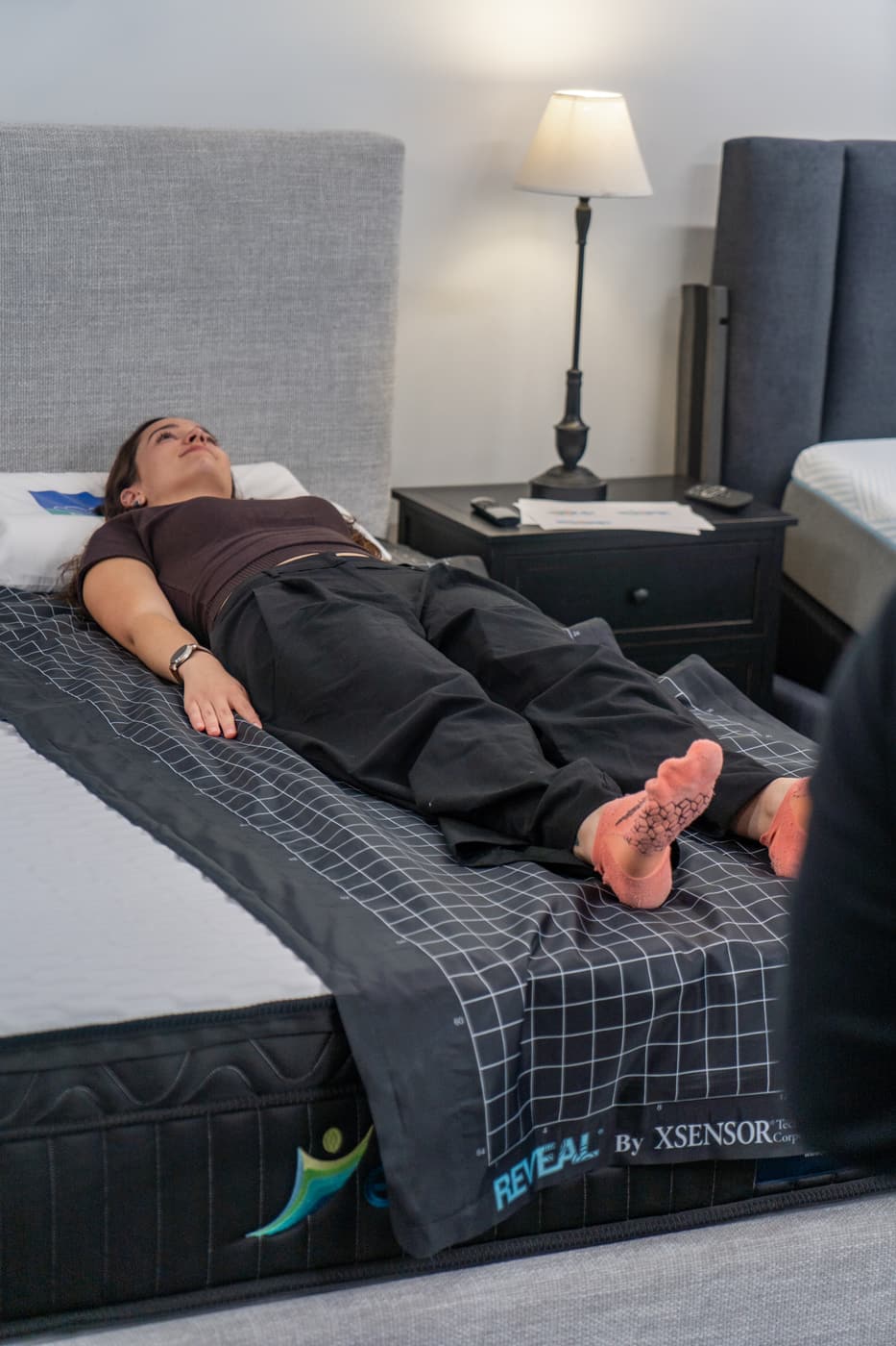 Customer lying on sensor mat beside live colour-map display